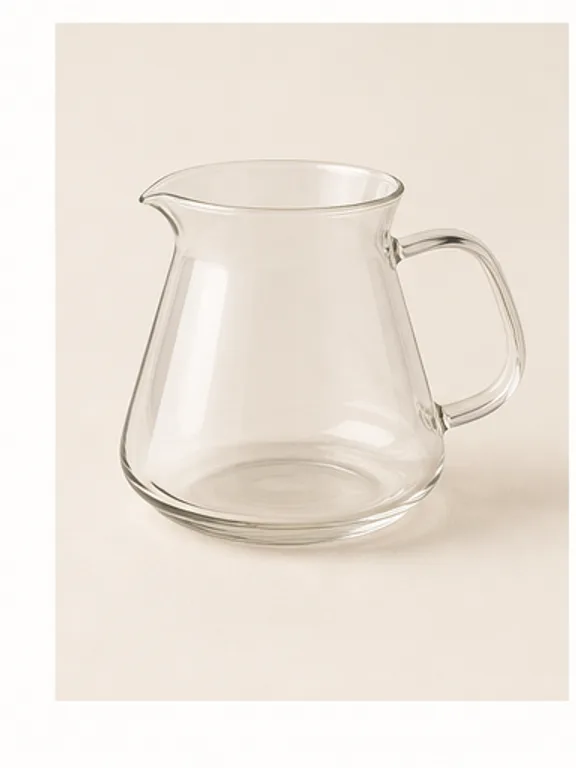 Clear glass coffee carafe holding a warm amber brew